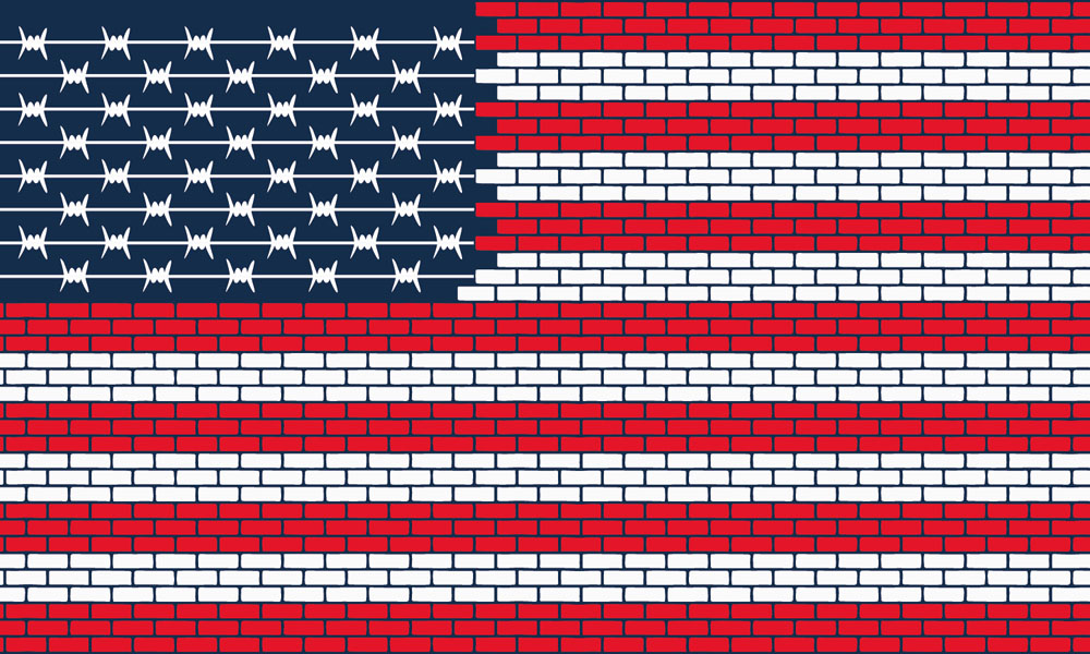 The USA flag made of bricks and barbed wire.